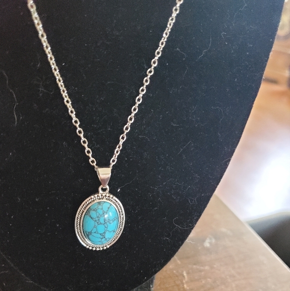 This a turquoise pendent on a silver necklace. - Picture 1 of 2